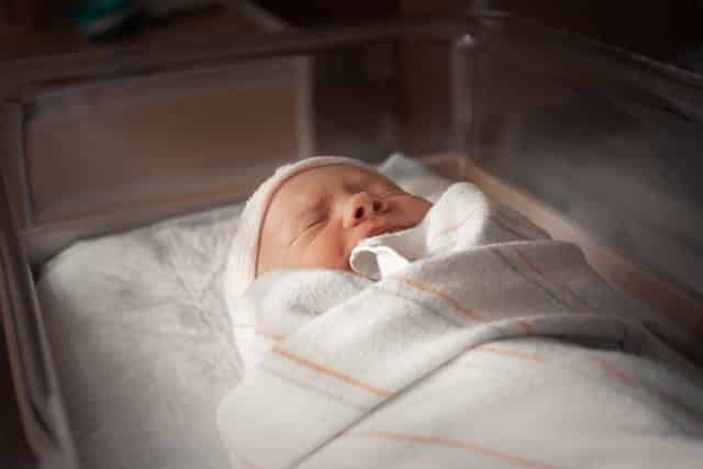 A swaddled newborn baby